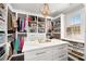 Spacious closet with ample shelving, center island, and natural light from a window at 255 Marjean Way, Alpharetta, GA 30009