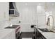 Modern kitchen featuring white cabinetry, marble backsplash, and stainless steel appliances at 255 Marjean Way, Alpharetta, GA 30009