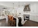 Bright, open kitchen with a black and white island, Wolf range, and decorative vent hood at 255 Marjean Way, Alpharetta, GA 30009