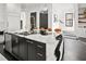 Stunning kitchen island featuring seating, marble countertops, and black cabinets with gold hardware at 255 Marjean Way, Alpharetta, GA 30009