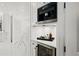 Modern kitchen nook equipped with a built-in Miele coffee maker and a beverage refrigerator at 255 Marjean Way, Alpharetta, GA 30009