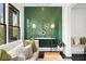 Stylish living area with emerald green tiled wall, modern decor, and cozy seating at 255 Marjean Way, Alpharetta, GA 30009