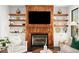 Cozy living room featuring a unique wood-paneled fireplace and built-in shelving at 255 Marjean Way, Alpharetta, GA 30009