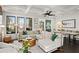 Spacious living room with large windows, fireplace, and adjacent dining area at 255 Marjean Way, Alpharetta, GA 30009