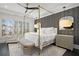 Luxurious bedroom with a four-poster bed, plantation shutters, and a ceiling fan at 255 Marjean Way, Alpharetta, GA 30009