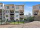 Rear view of townhome featuring private balconies, patio, and landscaped yard at 255 Marjean Way, Alpharetta, GA 30009