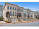 Charming street view of townhouses with brick facades, garages, and landscaped front yards at 255 Marjean Way, Alpharetta, GA 30009