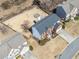 Aerial view of home with spacious backyard featuring fire pit seating area, fenced yard and mature trees at 239 Sumac Trl, Woodstock, GA 30188