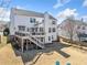Expansive backyard featuring a spacious deck with stairs and a convenient outdoor bar area, perfect for entertaining at 239 Sumac Trl, Woodstock, GA 30188