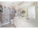 Bathroom features a double sink vanity, large mirror, wood-look flooring, and a unique shower curtain at 239 Sumac Trl, Woodstock, GA 30188