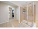 Shower room with neutral tiling, glass enclosure, and a doorway leading to the walk in closet at 239 Sumac Trl, Woodstock, GA 30188