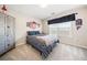 Carpeted bedroom featuring a window with blinds, a large cabinet, and sports-themed decor at 239 Sumac Trl, Woodstock, GA 30188