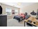 Bedroom with neutral carpet, dual windows and minimalist decor with a desk and dresser at 239 Sumac Trl, Woodstock, GA 30188