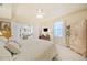 Bright bedroom with ceiling fan, French doors to the living room, and light wood armoire at 239 Sumac Trl, Woodstock, GA 30188