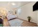 Spare bedroom with wood floors, TV and comfortable bed at 239 Sumac Trl, Woodstock, GA 30188