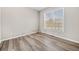 Bedroom has hardwood floors, a large window and white trim at 239 Sumac Trl, Woodstock, GA 30188