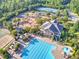 Community amenities featuring a pool, clubhouse, playground, and tennis courts surrounded by trees, and green landscaping at 239 Sumac Trl, Woodstock, GA 30188