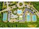 Aerial view of community amenities including a pool, tennis courts, playground, and clubhouse surrounded by lush landscaping at 239 Sumac Trl, Woodstock, GA 30188