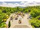 Community playground with a variety of play structures, set against a backdrop of lush trees and clear blue sky at 239 Sumac Trl, Woodstock, GA 30188