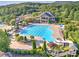 Community pool aerial view features a large pool, water slide, ample seating, and lush landscaping for a resort-like experience at 239 Sumac Trl, Woodstock, GA 30188