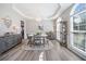 Bright dining room with large windows, trey ceiling, chandelier, light gray walls, and stylish gray buffet at 239 Sumac Trl, Woodstock, GA 30188