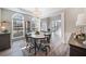 Cozy dining room with chandelier, large bay windows, and light grey walls, molding and wood look floors at 239 Sumac Trl, Woodstock, GA 30188