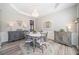 Bright dining room features elegant chandelier, large buffet, light grey walls and trim, and grey wood floors at 239 Sumac Trl, Woodstock, GA 30188