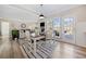 The dining room offers a table and chairs, access to the living room, and doors to an outdoor deck for dining al fresco at 239 Sumac Trl, Woodstock, GA 30188
