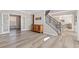 Bright entryway features hardwood floors, staircase and glass panel doors leading to another room at 239 Sumac Trl, Woodstock, GA 30188