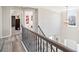 The foyer features an open staircase with decorative metal railing and wood floors with views of the front entrance at 239 Sumac Trl, Woodstock, GA 30188