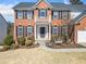 Inviting front entrance with a charming balcony, black shutters, and a bench at 239 Sumac Trl, Woodstock, GA 30188
