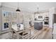 Bright kitchen features white cabinets, stainless steel appliances and a nearby dining area at 239 Sumac Trl, Woodstock, GA 30188