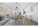 Bright kitchen features white cabinets, stainless steel appliances and a nearby dining area at 239 Sumac Trl, Woodstock, GA 30188