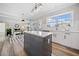 Spacious kitchen showcases white cabinets, subway tile backsplash, and an island with seating and a connection to the dining room at 239 Sumac Trl, Woodstock, GA 30188