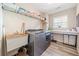 Laundry room features a modern washer and dryer, overhead shelving, a sink, and counter space at 239 Sumac Trl, Woodstock, GA 30188