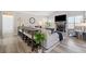 Open concept shows a living room with a long table, hardwood floors, and large windows at 239 Sumac Trl, Woodstock, GA 30188