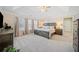 The spacious main bedroom features a trey ceiling, carpet floors, and lots of natural light from the three large windows at 239 Sumac Trl, Woodstock, GA 30188