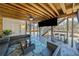 Under-deck patio featuring a large tv, stone floor, comfortable seating and overhead fan at 239 Sumac Trl, Woodstock, GA 30188