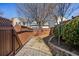 Fenced backyard featuring a stone retaining wall and walkway at 4309 Elliott Way, Smyrna, GA 30082