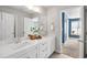 Bright bathroom featuring double sinks, white cabinets, quartz countertop, and modern fixtures at 4309 Elliott Way, Smyrna, GA 30082