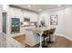 Modern kitchen featuring white cabinets, stainless steel appliances, granite countertops, and a stylish island with bar seating at 4309 Elliott Way, Smyrna, GA 30082