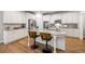 Bright kitchen boasts white cabinets, stainless steel appliances, granite countertops, and a large island with seating at 4309 Elliott Way, Smyrna, GA 30082