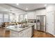 Open-concept kitchen with stainless steel appliances, granite island, and seamless flow into the adjacent living area at 4309 Elliott Way, Smyrna, GA 30082