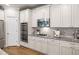 White cabinets, granite countertops, stainless appliances, and wood floors enhance this stylish and functional kitchen at 4309 Elliott Way, Smyrna, GA 30082