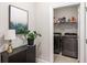 Practical laundry room with modern machines and storage shelves, conveniently located near the main living areas at 4309 Elliott Way, Smyrna, GA 30082
