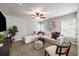 Spacious living room features modern ceiling fan, large windows, stylish seating, and neutral decor at 4309 Elliott Way, Smyrna, GA 30082