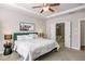 A main bedroom showing the bed, a ceiling fan, and a view to an ensuite bath at 4309 Elliott Way, Smyrna, GA 30082