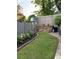 Landscaped backyard with a birdhouse, brick edging, and a well-maintained lawn at 60 Saddle Tree Way, Sugar Hill, GA 30518