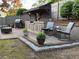 Outdoor kitchen area with seating, grill, and landscaping features at 60 Saddle Tree Way, Sugar Hill, GA 30518