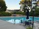Serene community pool surrounded by lounge chairs, tables, and umbrellas, for relaxation and recreation at 60 Saddle Tree Way, Sugar Hill, GA 30518